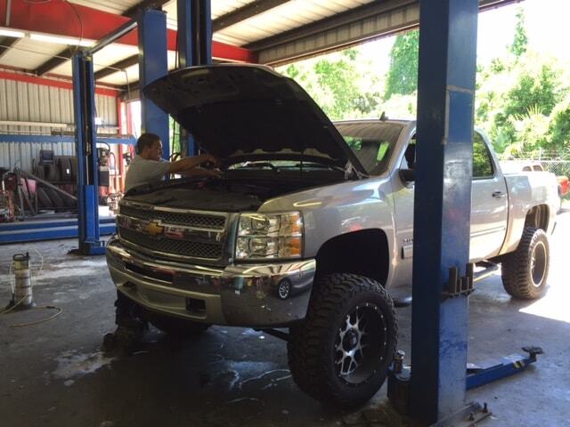 White truck undergoing diesel service