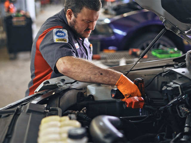 Chase Zembower Mechanic fixing Vehicle Engine