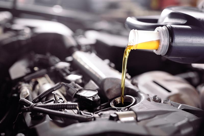 Motor oil pouring to car engine during fluid exchange